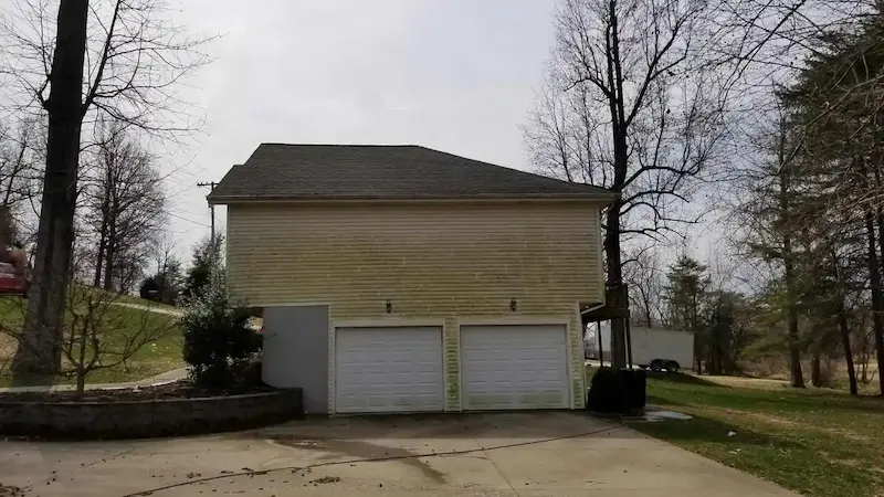 Dirty vinyl siding with algae